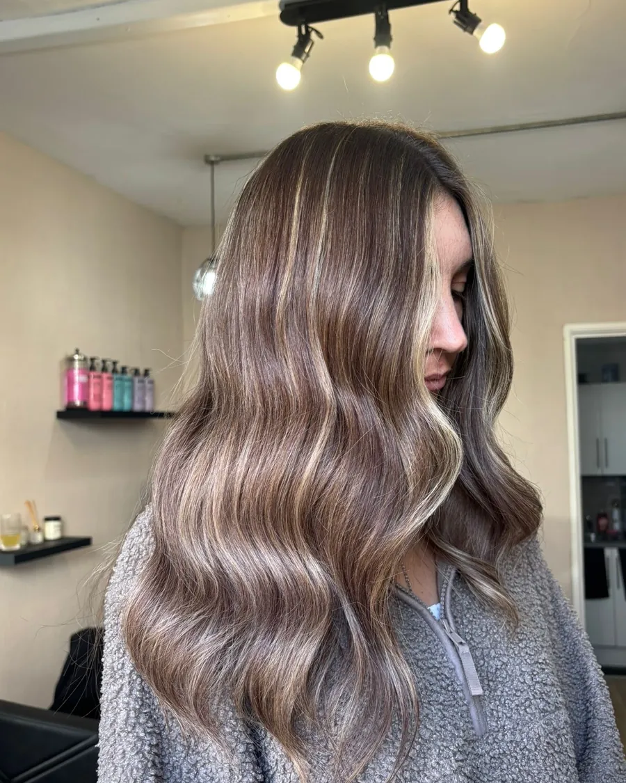 Long, glossy balayage waves in soft brown and caramel