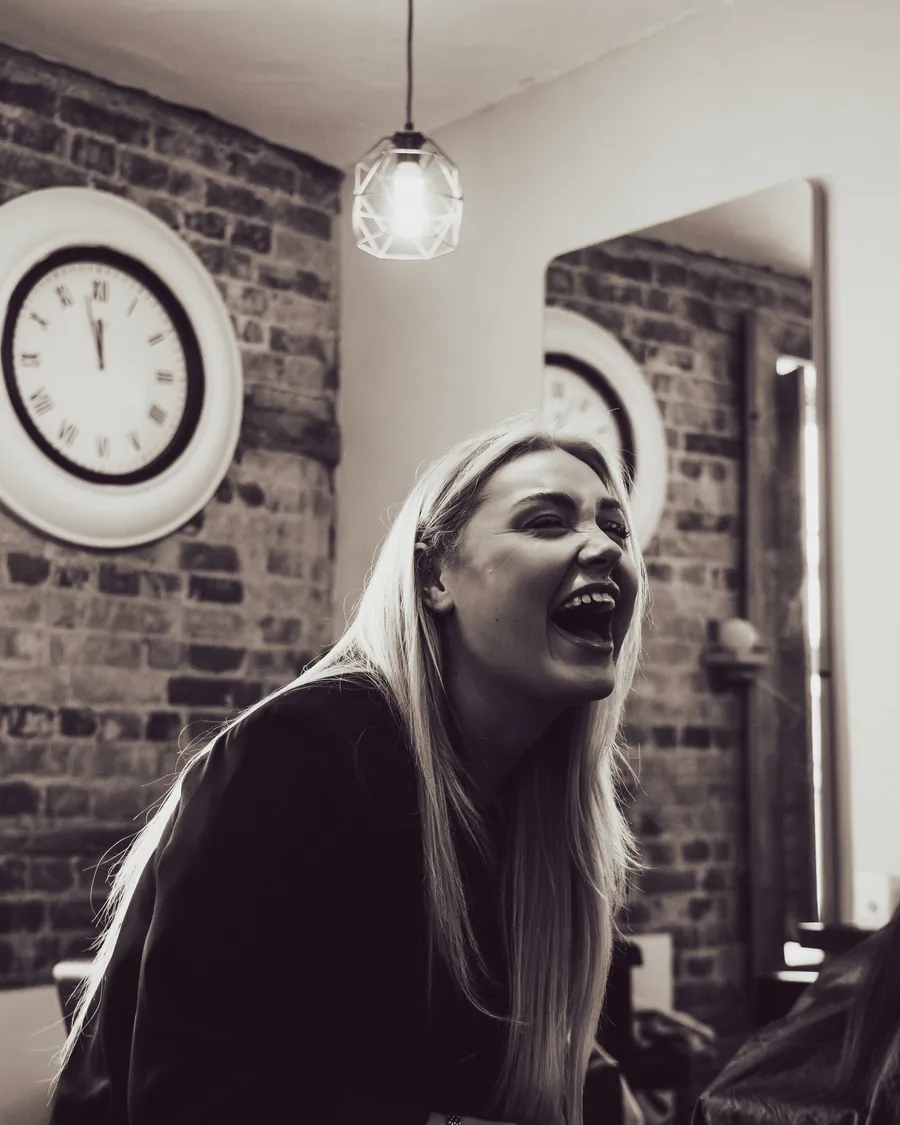 One of our hairdressers laughing in the salon